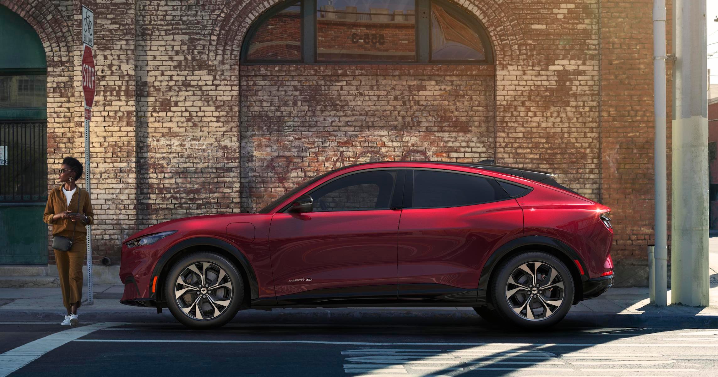 A red Ford Mustang Mach-E, an upscale sporty crossover SUV. 