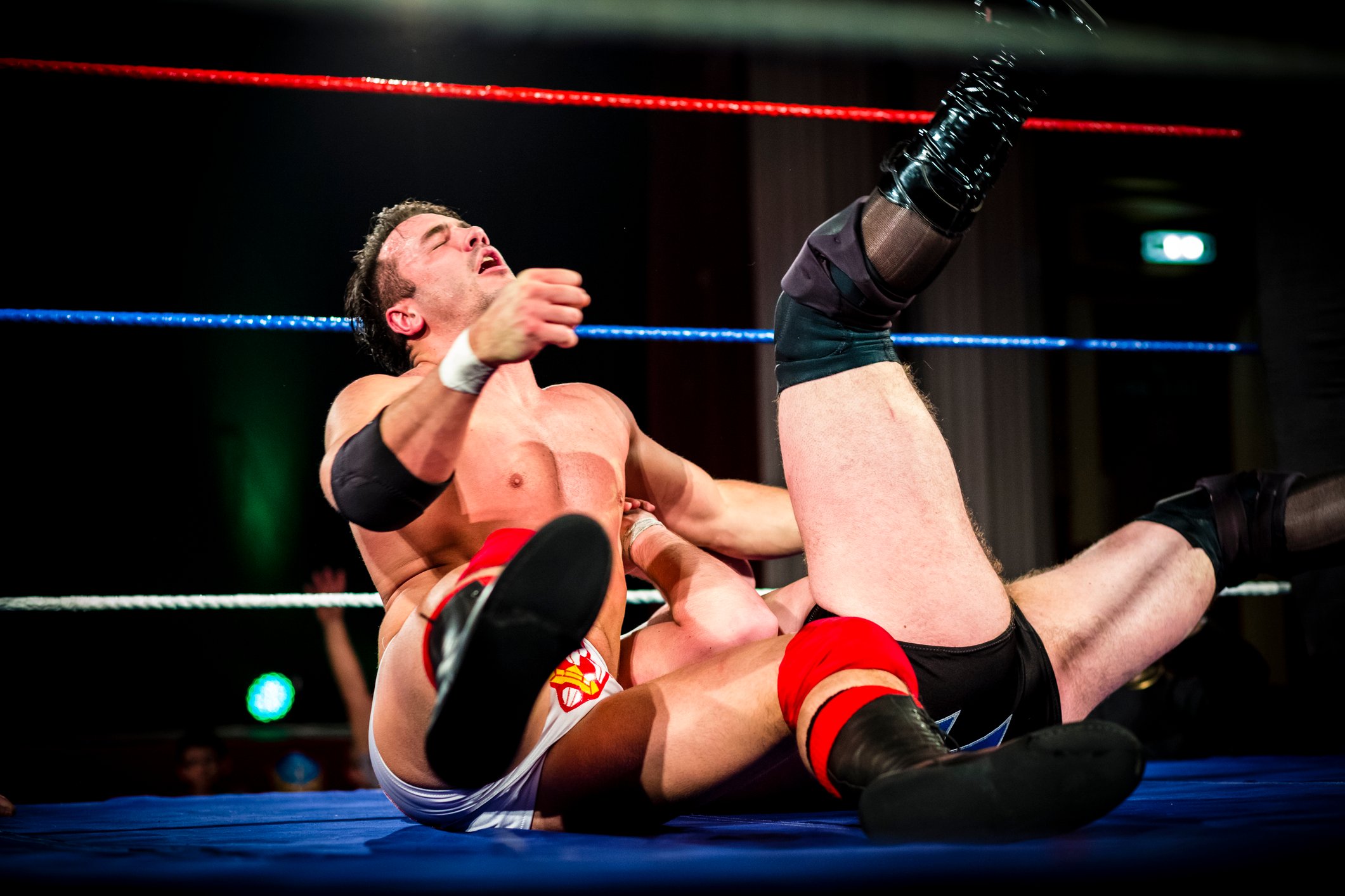Two pro wrestlers fighting in a ring.
