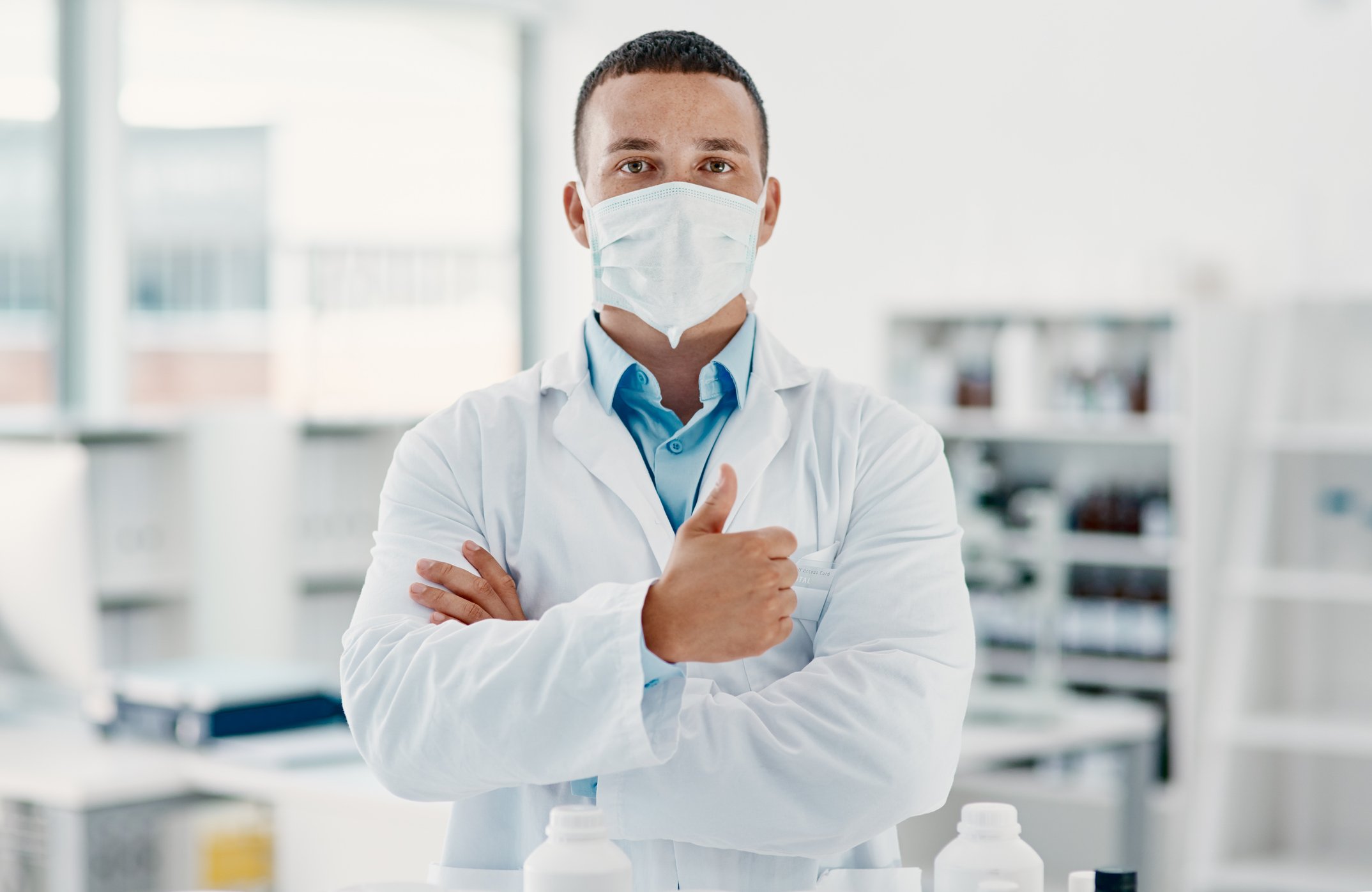 A scientist gives a thumbs up to the viewer.