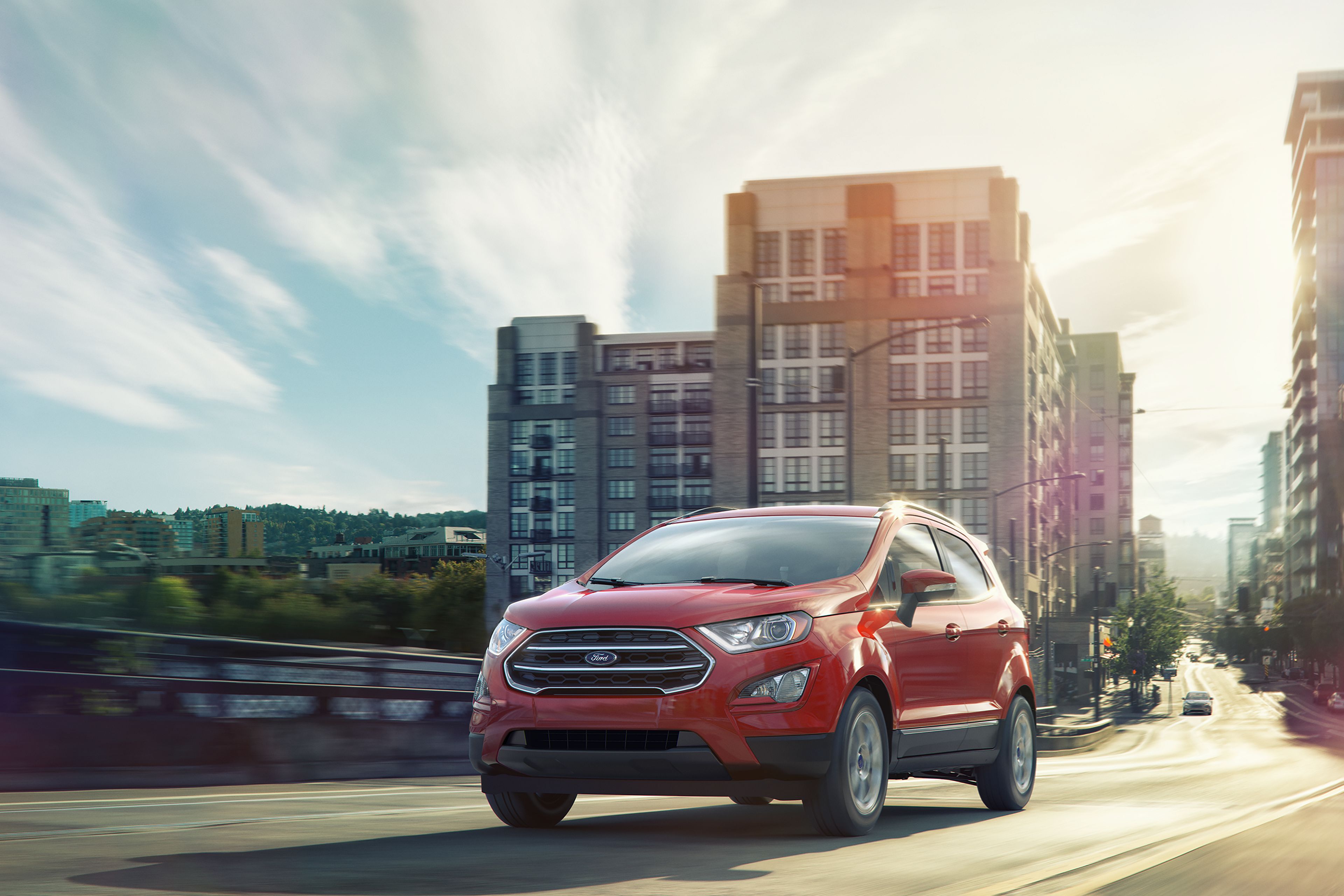 A red Ford EcoSport driving in a city. 