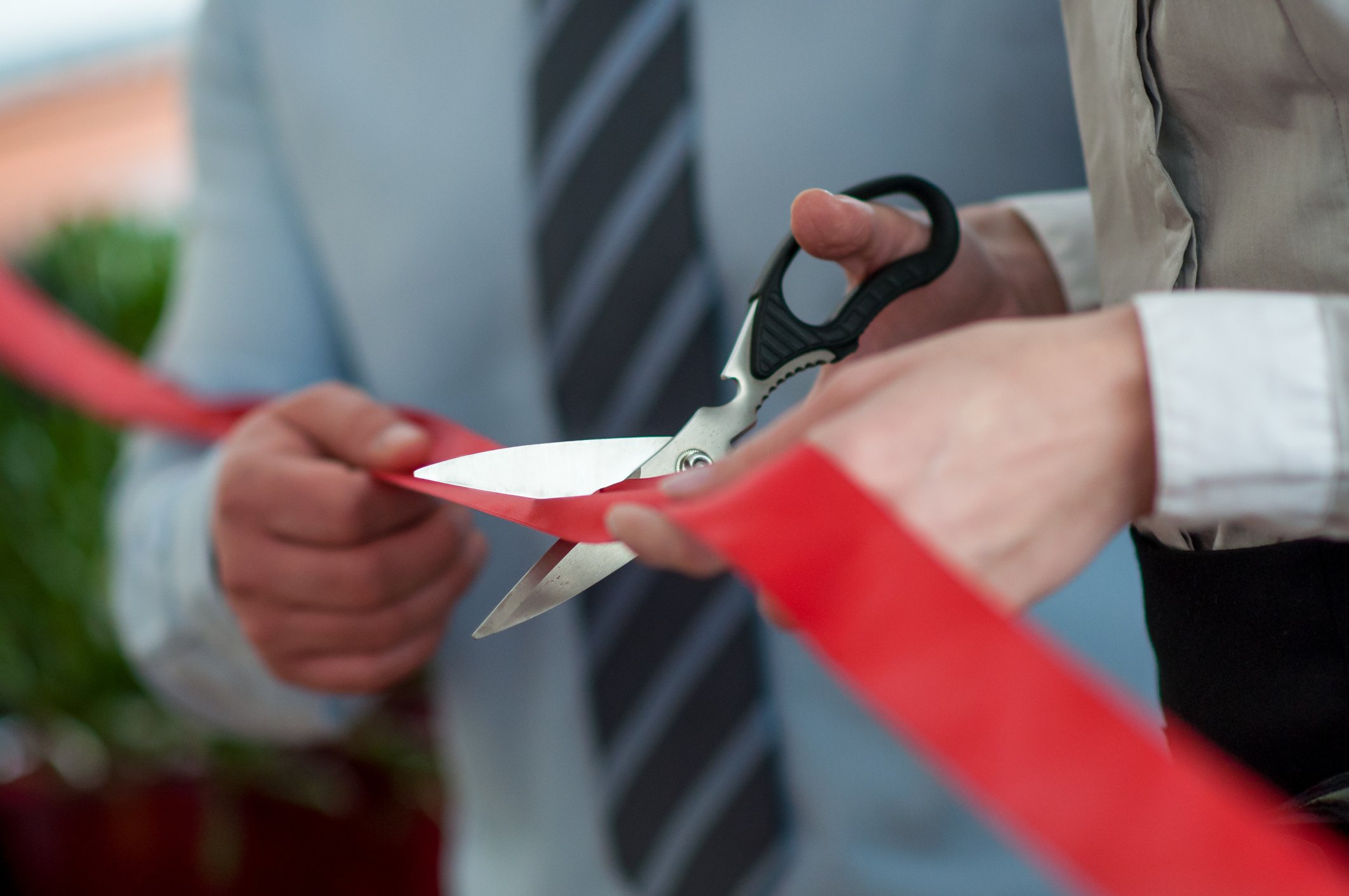 A ribbon cutting ceremony, representing the opening of a new restaurant.
