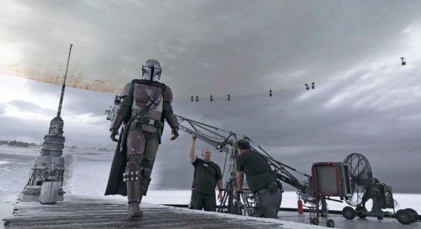 The Mandalorian walks across the StageCraft soundstage during production of the show.