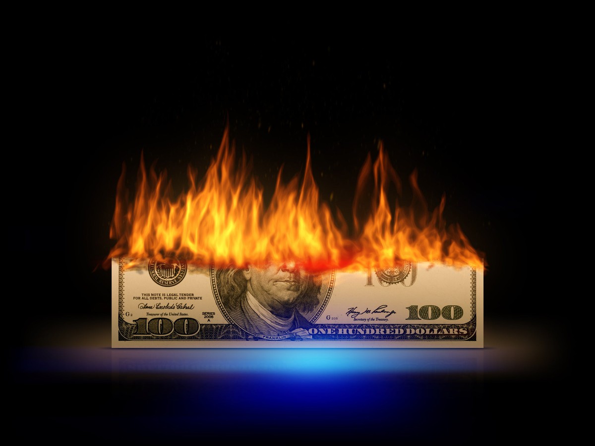 Hundred-dollar bill on fire.