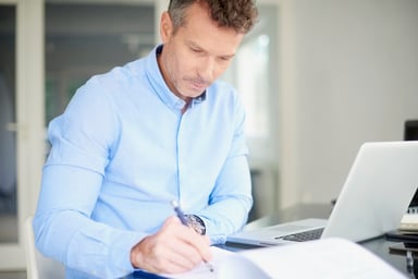 Man at laptop taking notes_GettyImages-1011923618