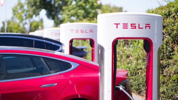 Tesla vehicles at a charging station.