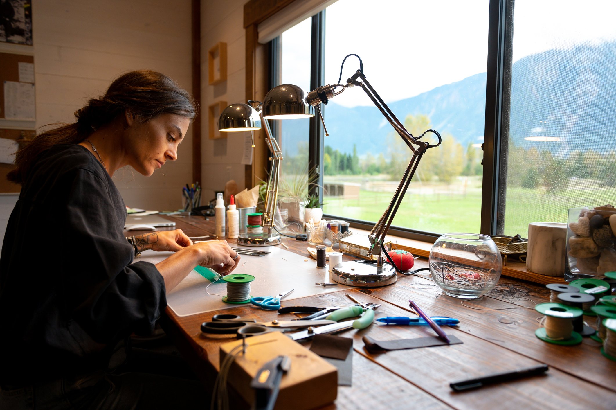 Woman making handcrafted items at table