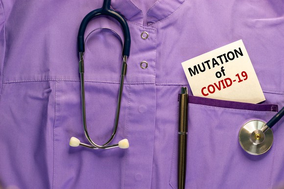 The image of a purple medical uniform is shown with a sign saying "mutation of COVID-19" in the pocket.