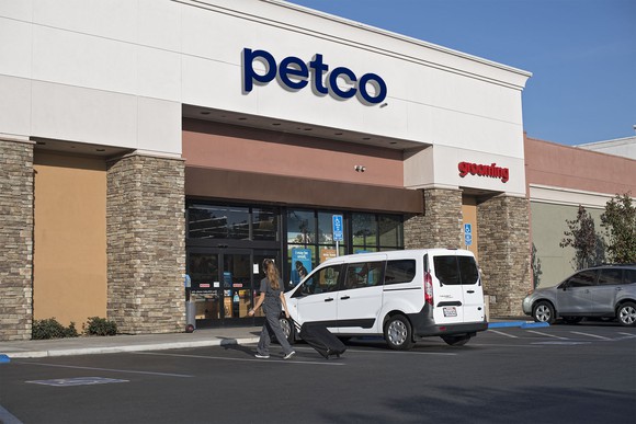 A Petco storefront with a minivan parked out front.