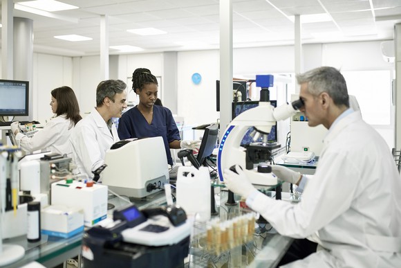 Four people working in a lab.