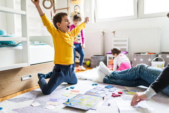 Child cheering over board game