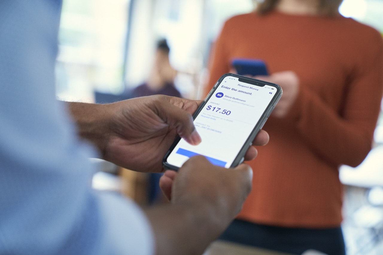 A man accessing his bank account information on his smartphone. 