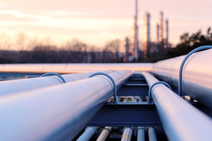 Long pipes in crude oil factory during sunset