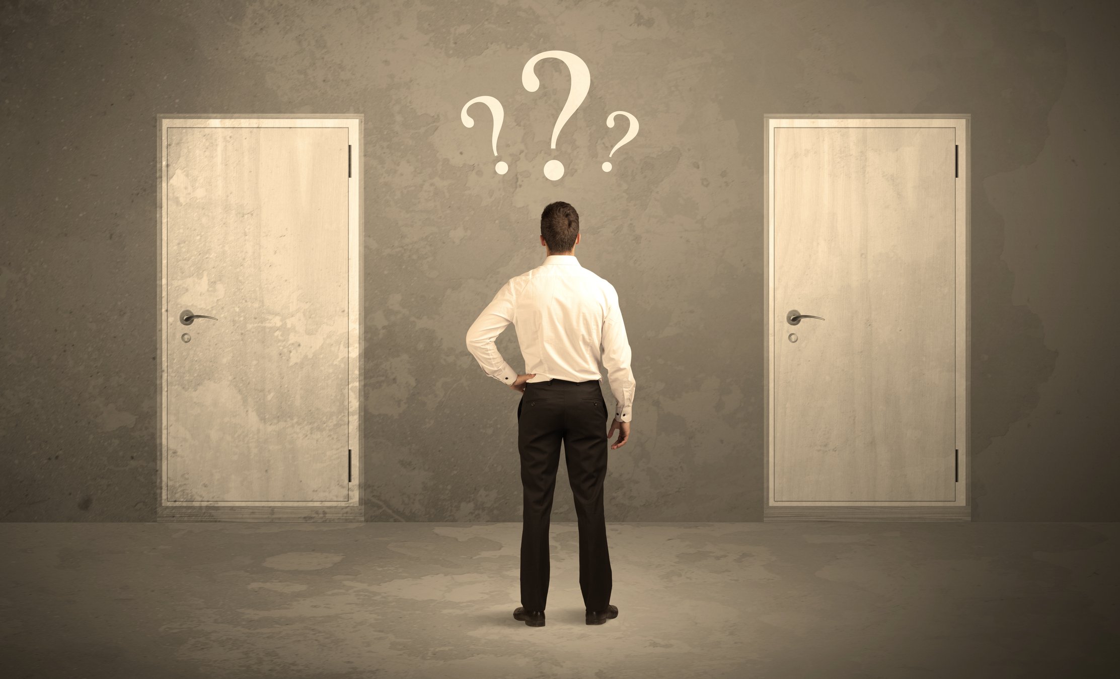 Man standing in front of two doors with question marks hovering above his head
