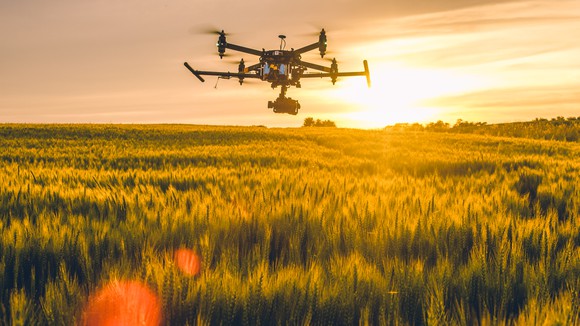 A drone hovers over a field.