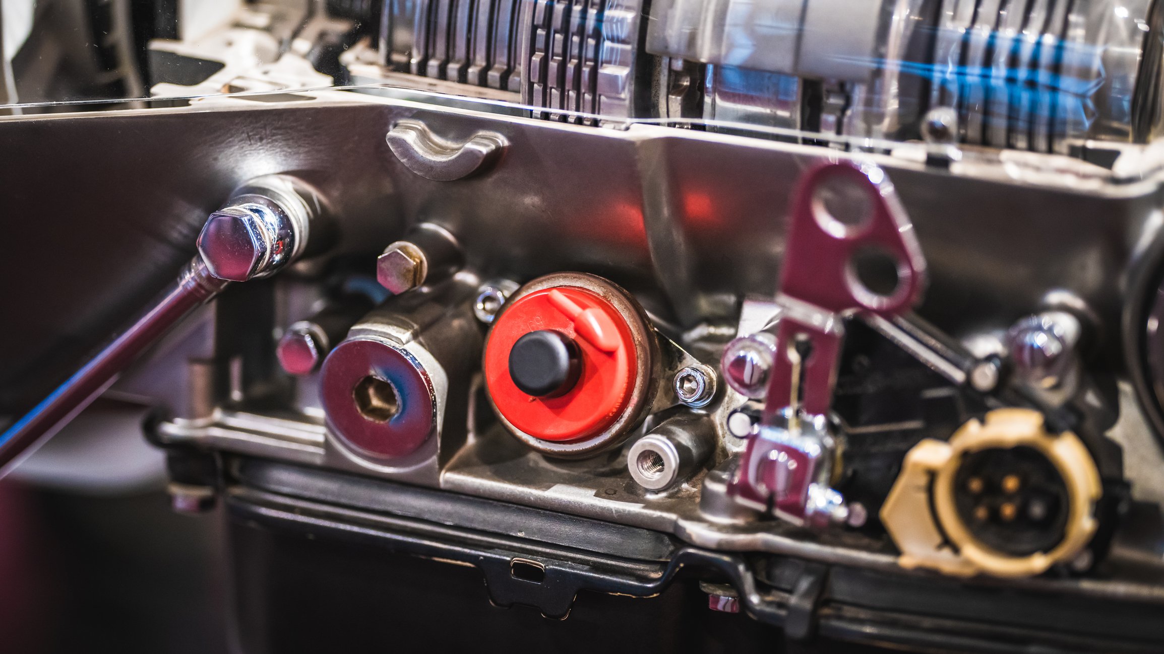 A close-up of pulley mechanisms on an industrial mechanical engine.