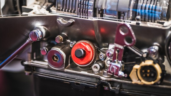 A close-up of pulley mechanisms on an industrial mechanical engine.