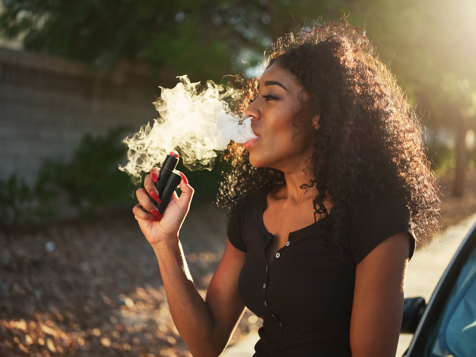 A young woman vaping.