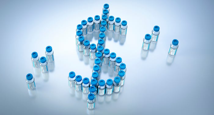 Vaccine vials forming the shape of a dollar sign