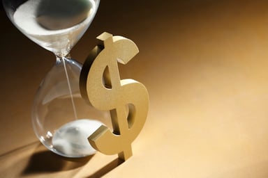 Hourglass next to dollar sign