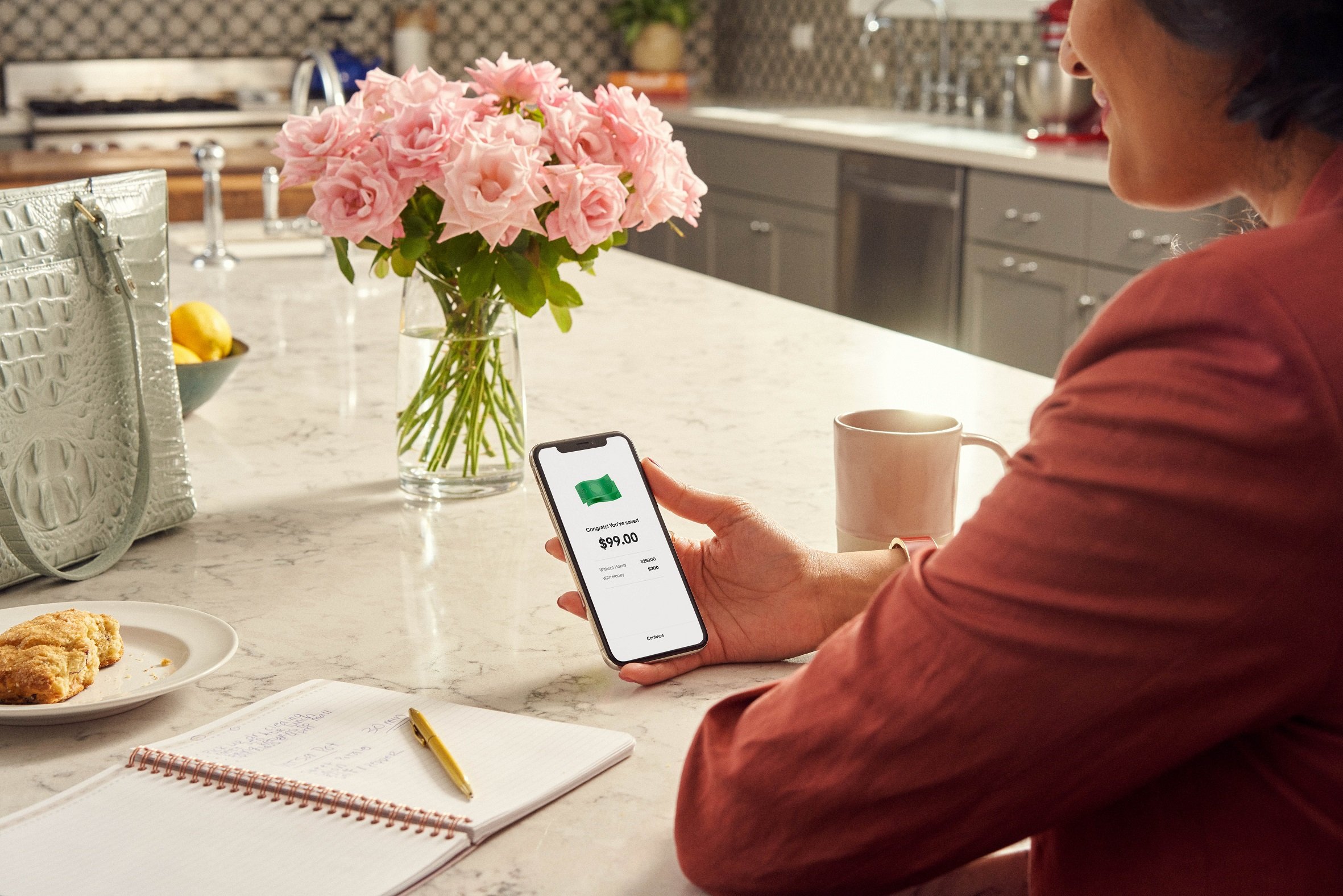 A woman using PayPal's Honey on a mobile phone.