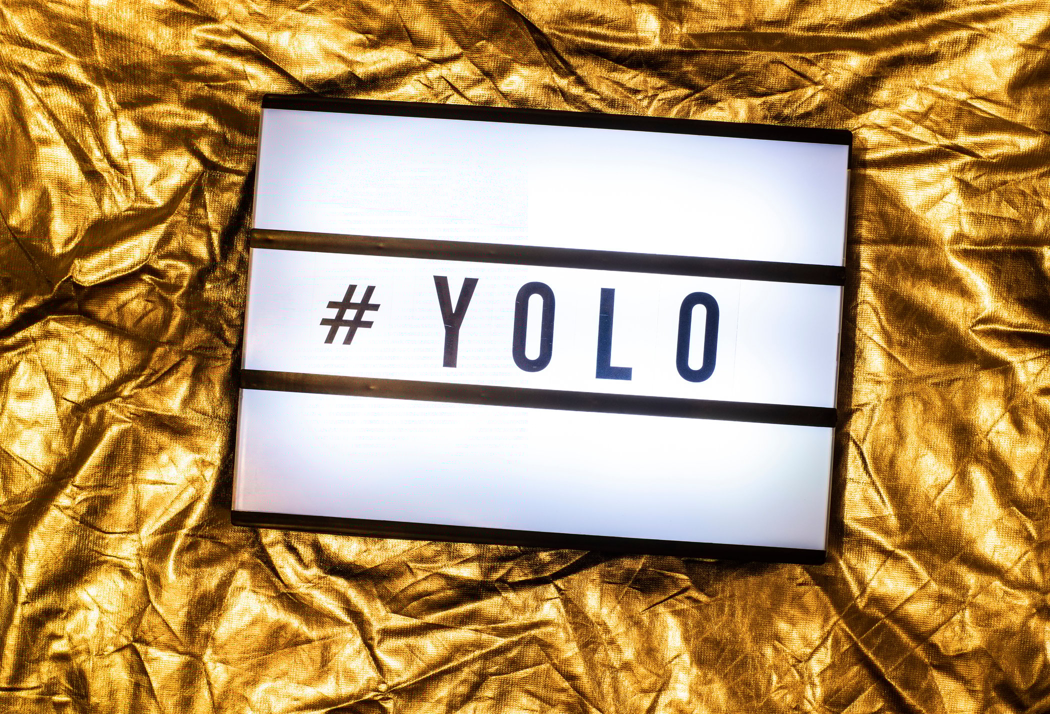 Sign with the letters YOLO on it.