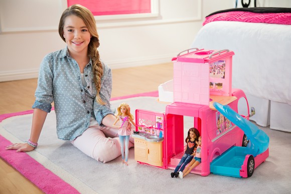 Girl playing with Barbie Dream House