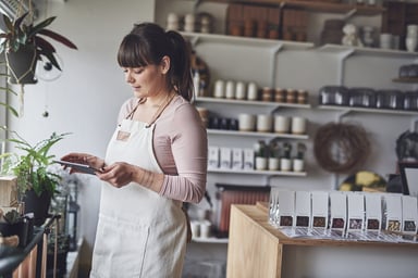 Florist smiling working on a tablet