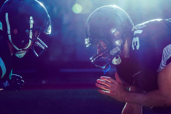 Football players lined up against one another