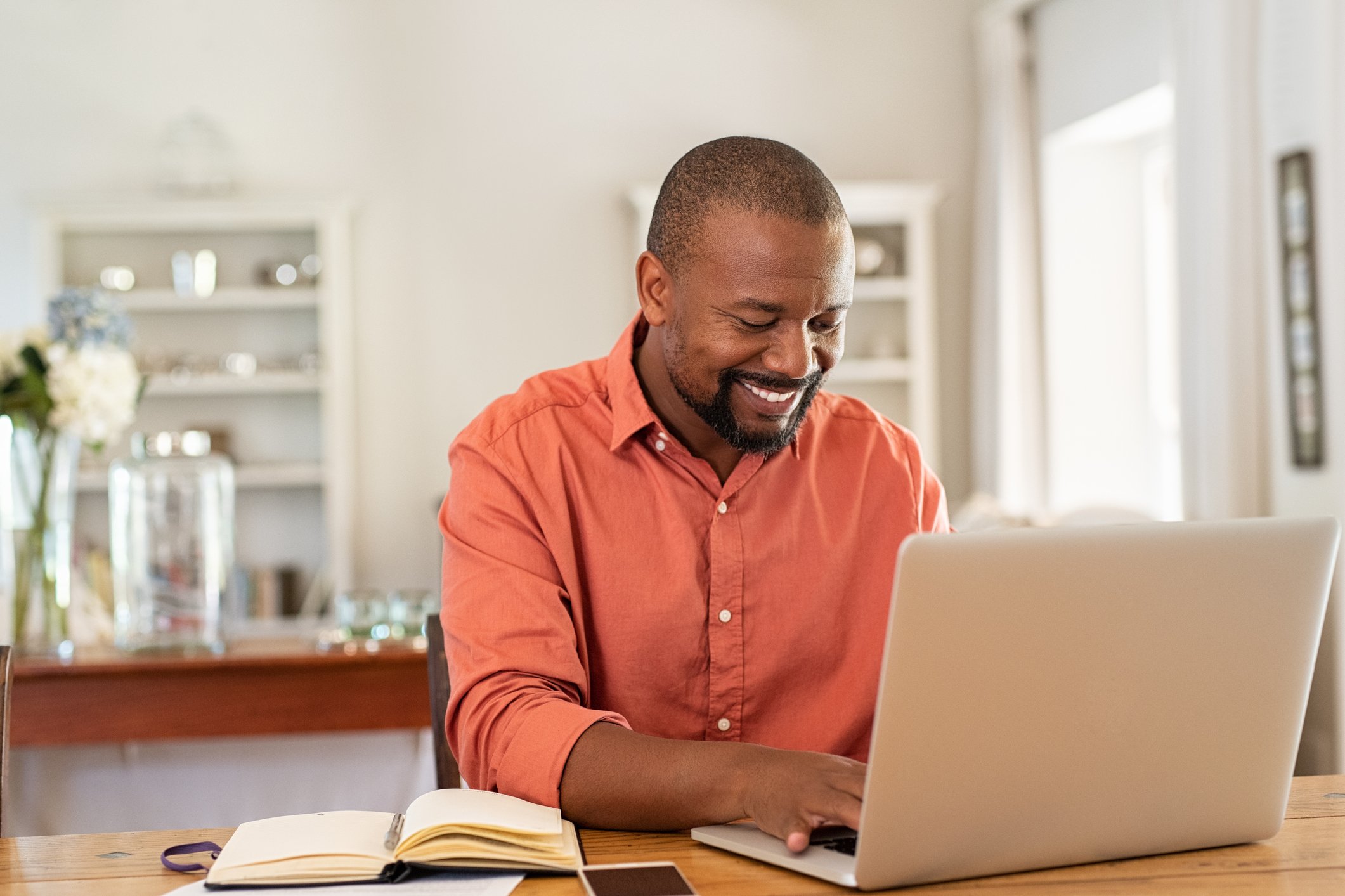 Smiling person at laptop.