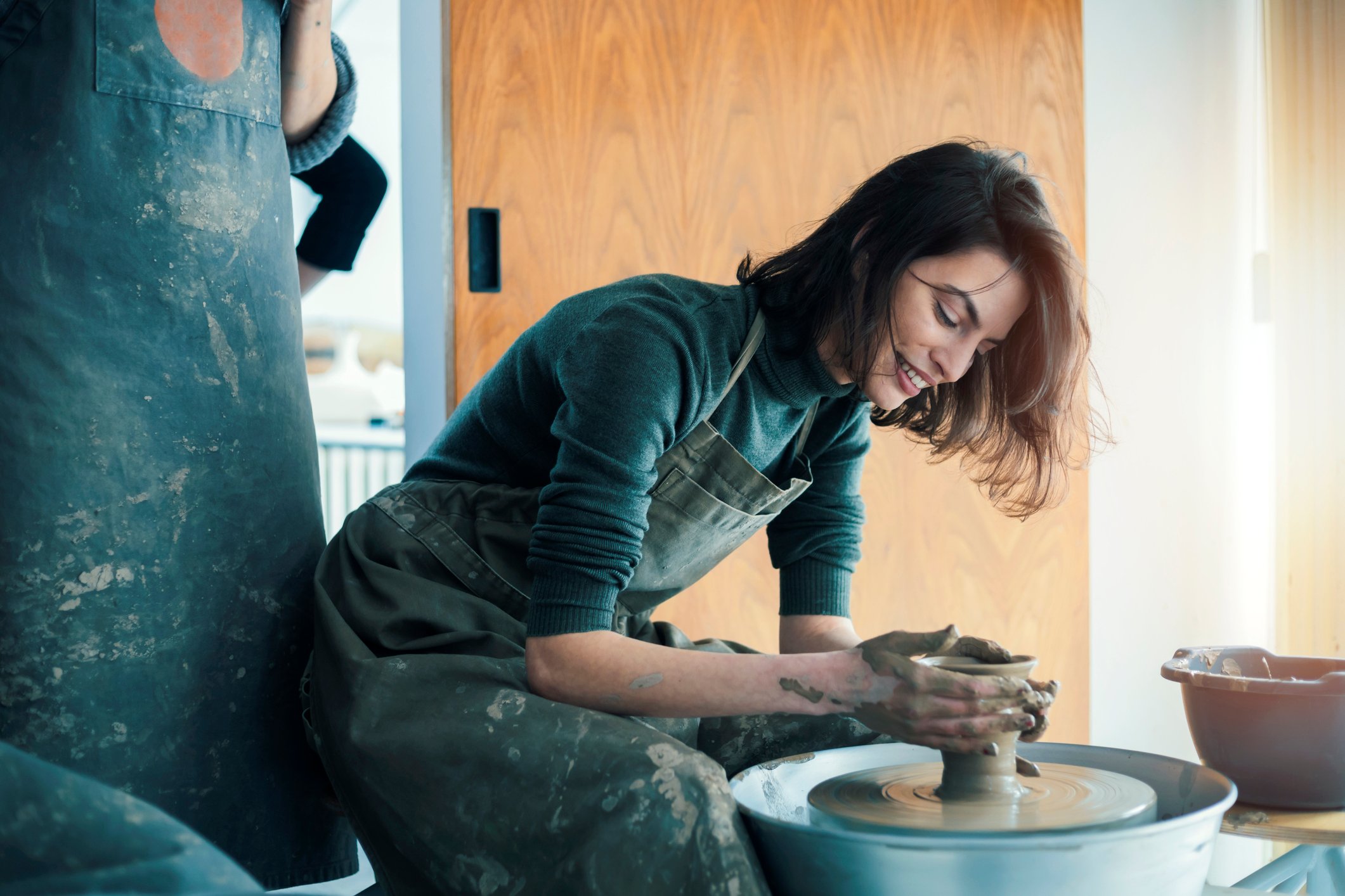 A woman making pottery.