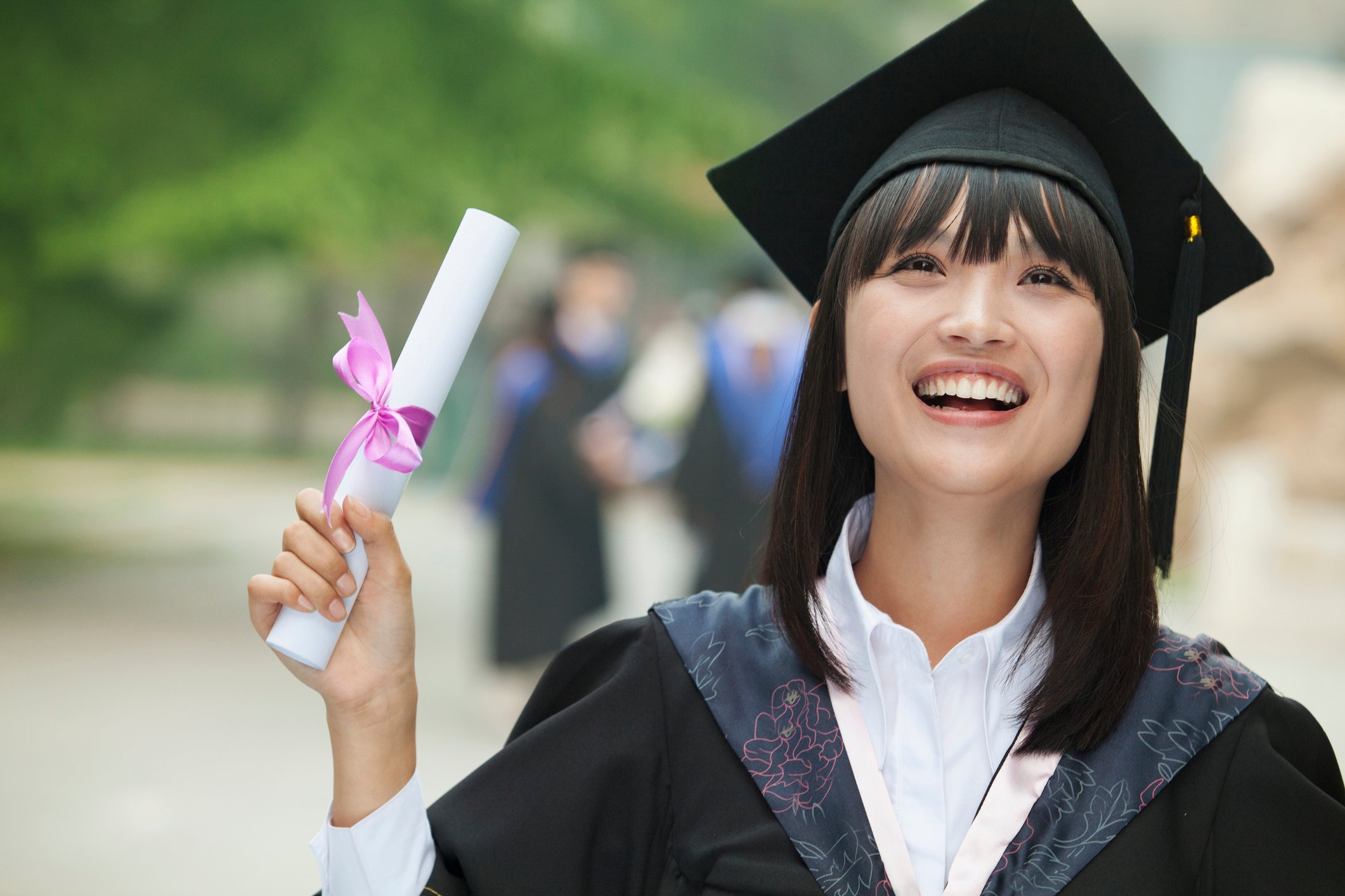 Happy woman holding diploma