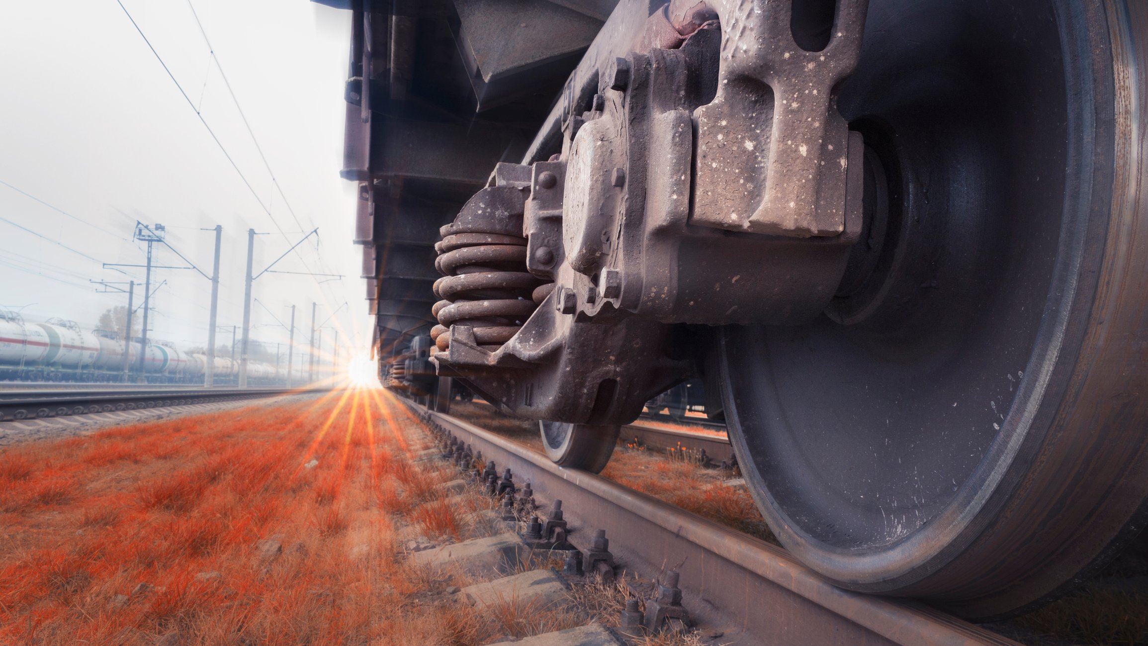 Close-up of freight train wheels on a track.