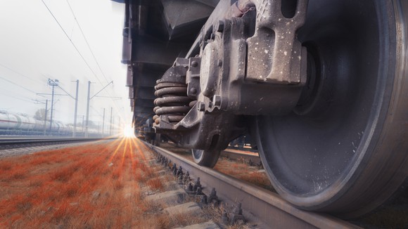 Close-up of freight train wheels on a track.