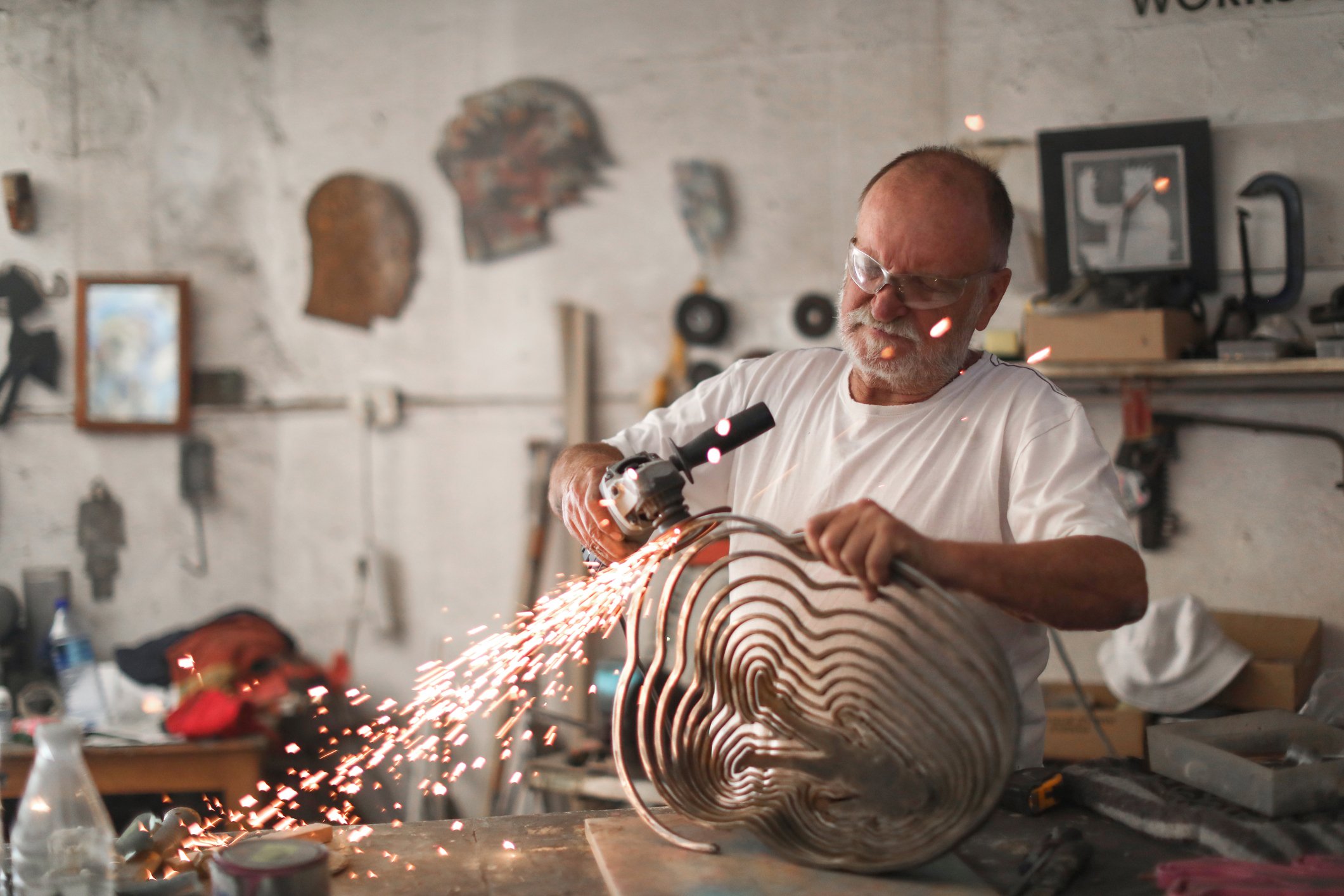 Retirement aged man metalworking