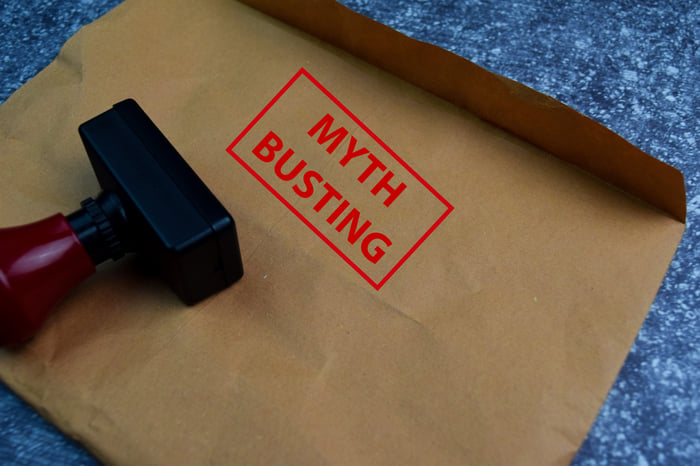 Stamp stamping the words Myth Busting on envelope