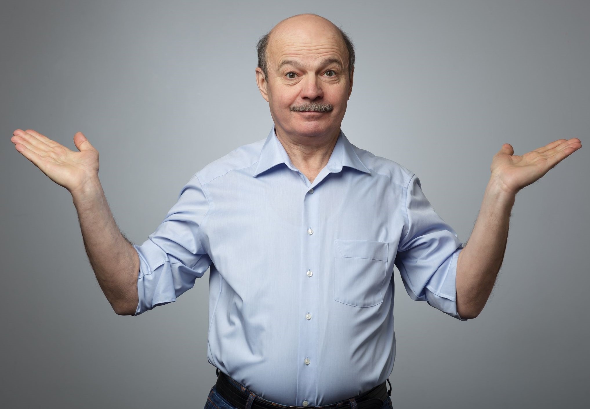 Confused-looking man shrugging. 