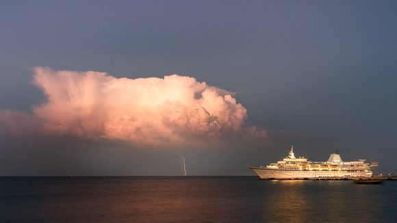 Lightning bolt from approaching storm near cruise ship