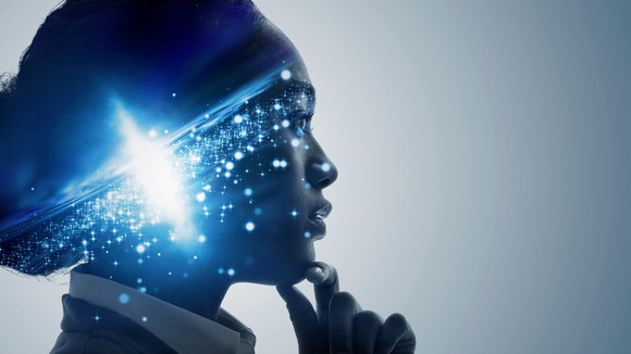 Thoughtful woman with image of galaxy in her head