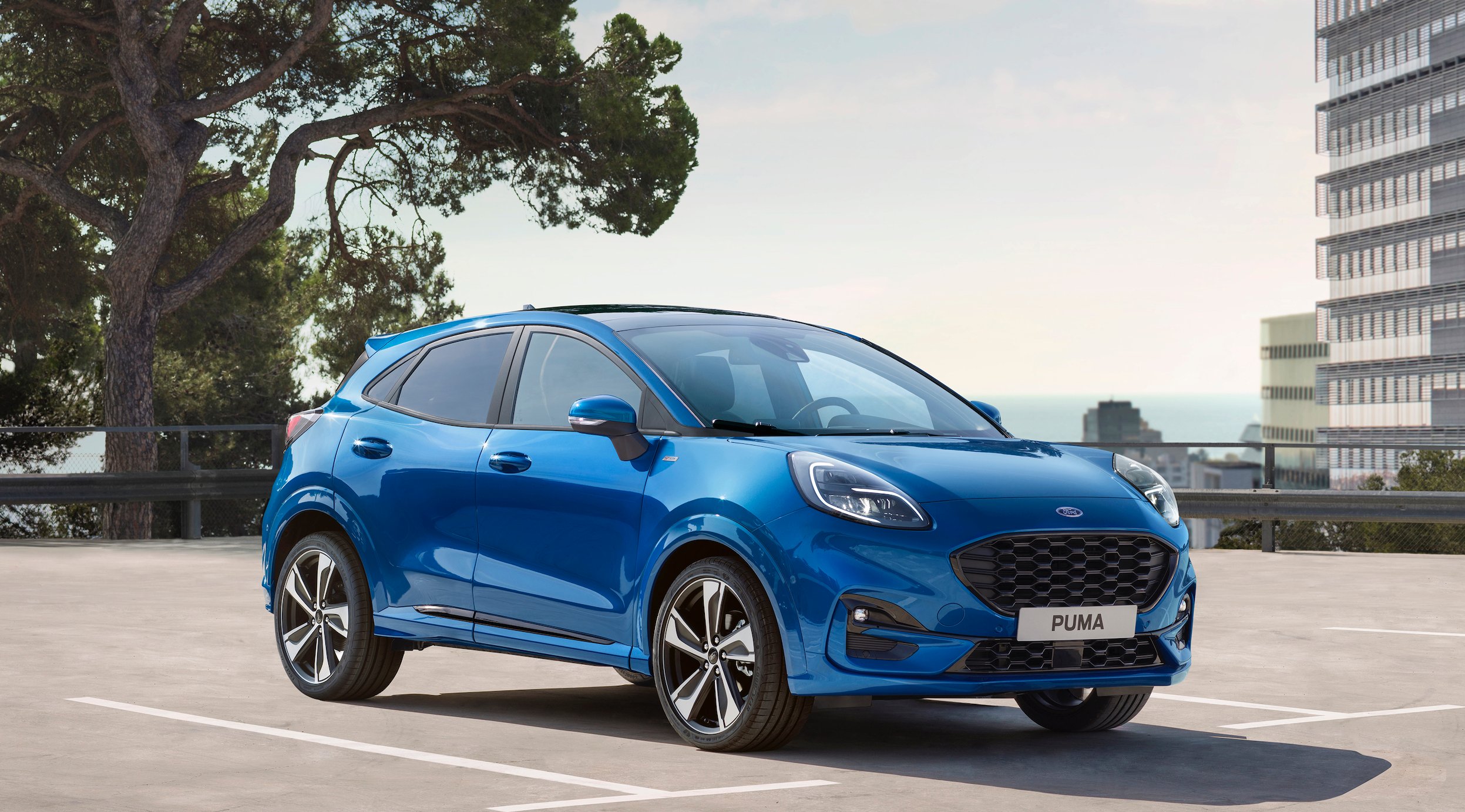 A blue Ford Puma, a small sporty crossover SUV.