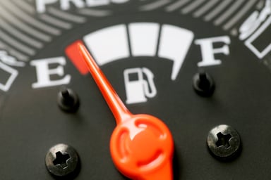 Fuel gauge with warning indicating low fuel tank.