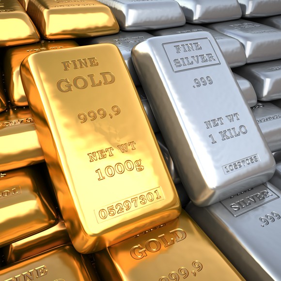 Gold and silver kilo bars next to each other.