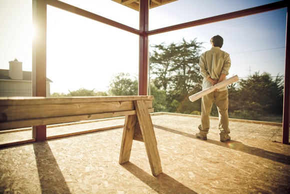 Builder standing in a construction site. 