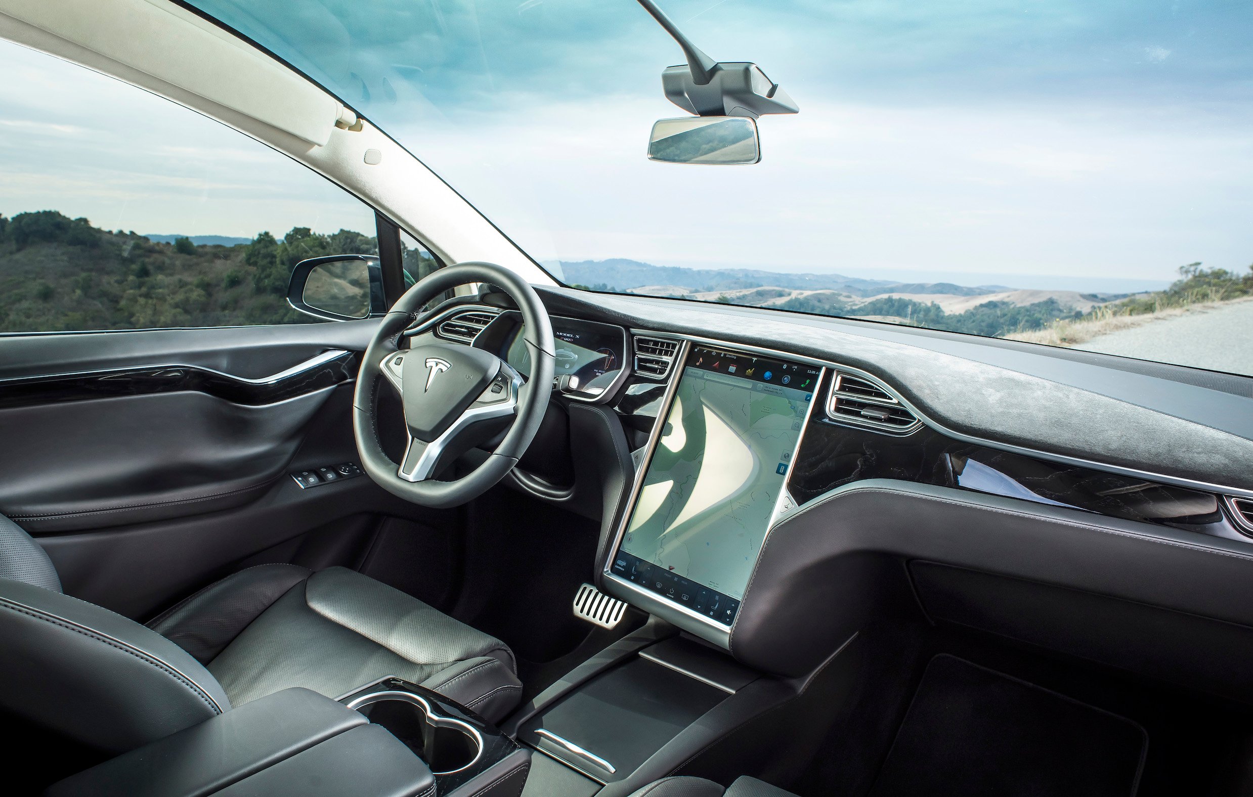 The dashboard of a Tesla Model X SUV, showing the large touchscreen. 