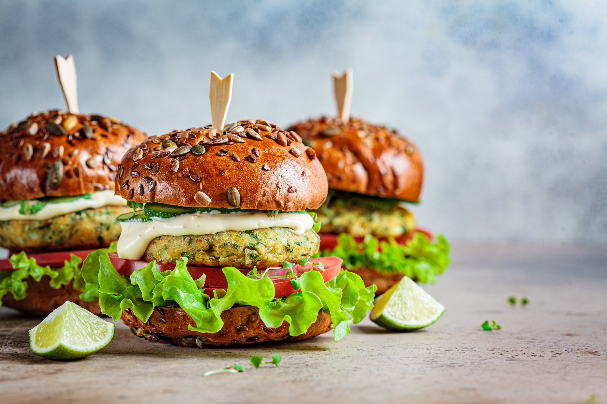 Three vegan burgers sitting in a triangle