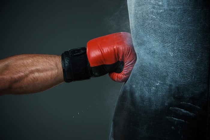 First with boxing glove hitting bag.