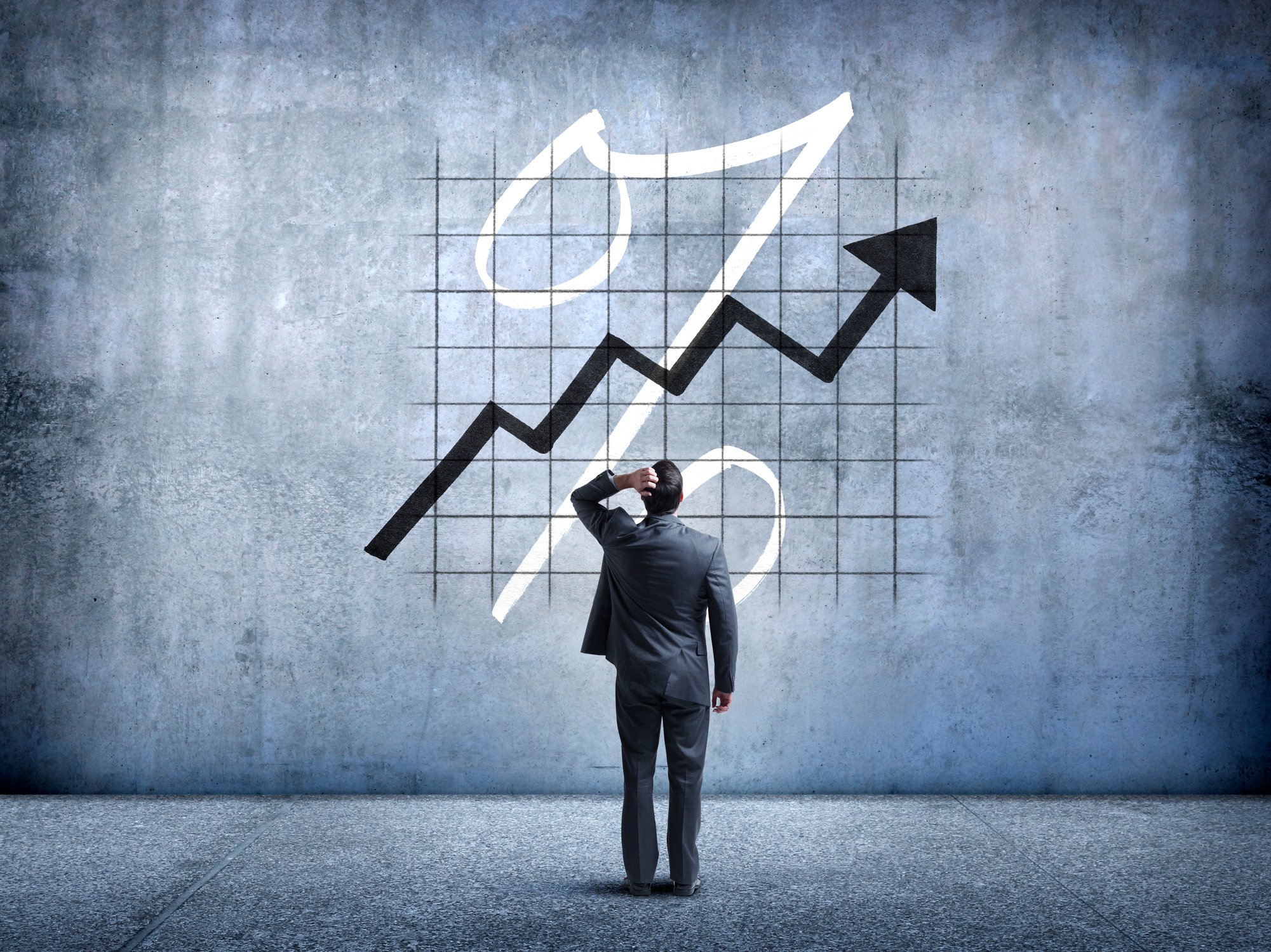 An investor holds his head as he looks at a graph showing short interest on the rise.