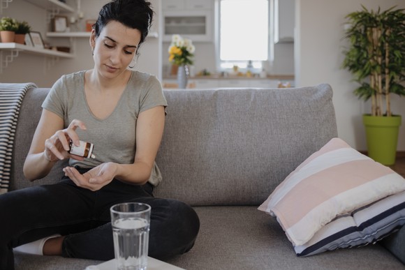 Woman taking a pill. 