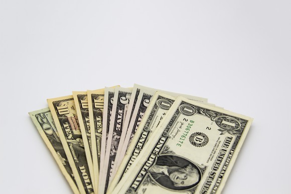 Fanned out bills ranging from ones to twenties.