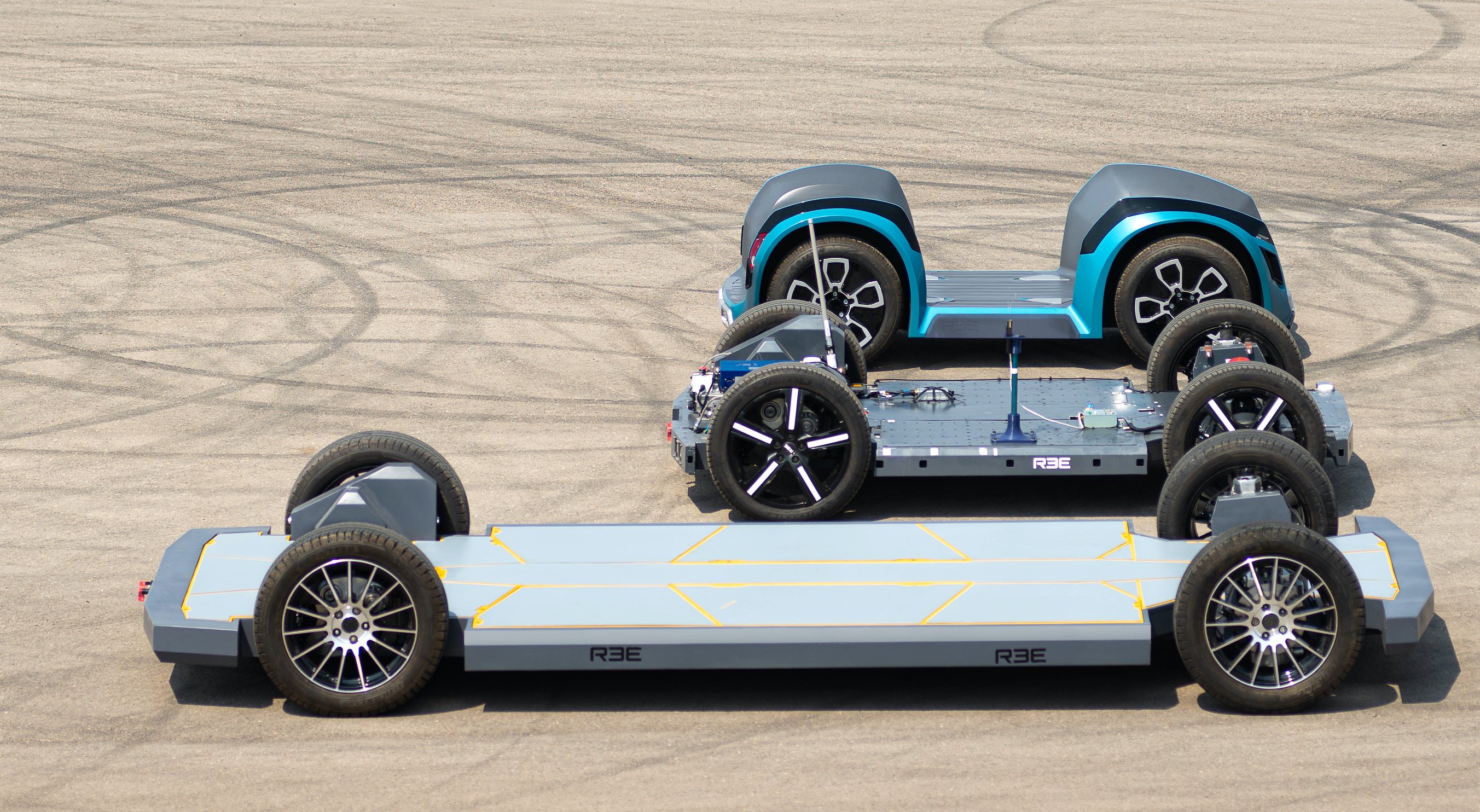 3 of REE's EV skateboards, in different sizes for different kinds of vehicles. 