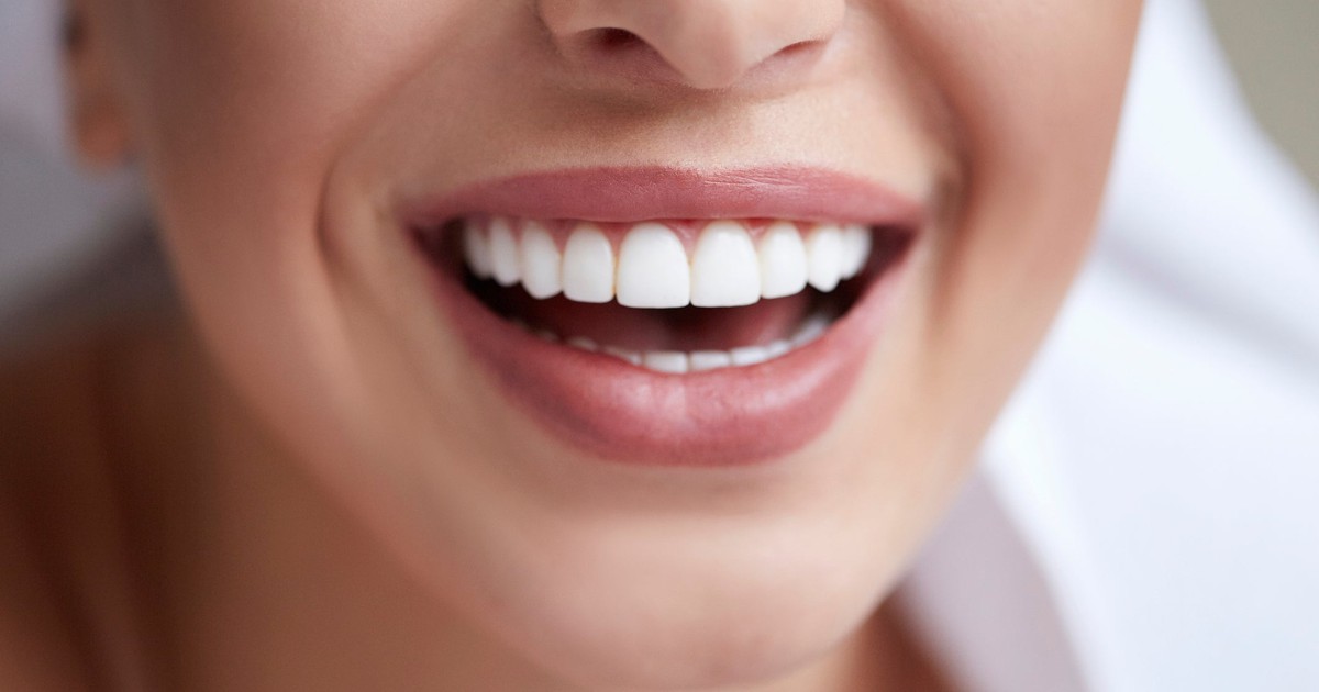Mouth of person smiling, showing teeth.